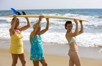 Family carrying surfboard