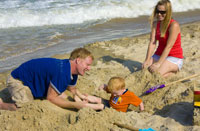 Family playing in sand